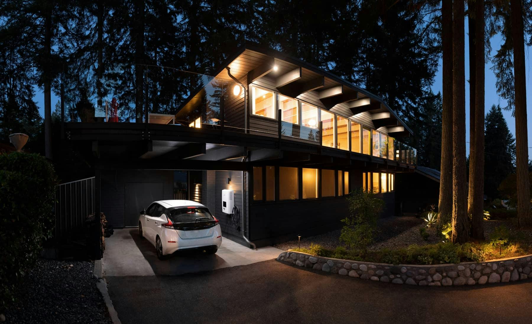 Modern house with an ev car in the driveway
